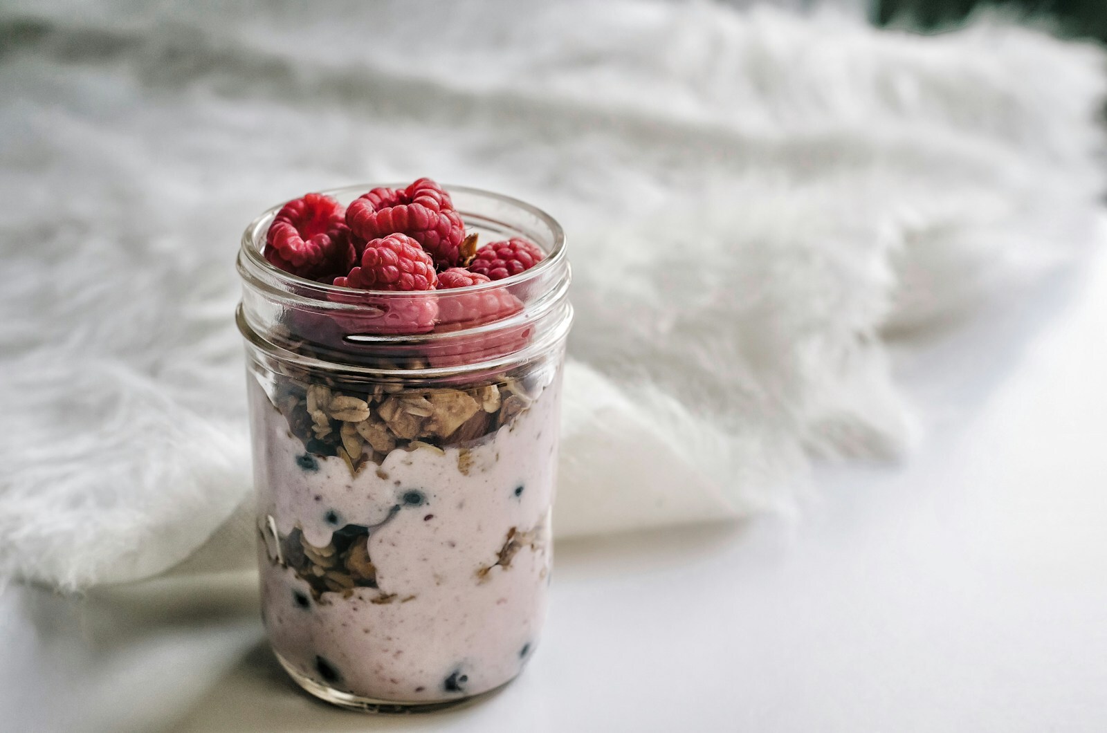 High-protein overnight oats with Greek yogurt, berries, and almond butter