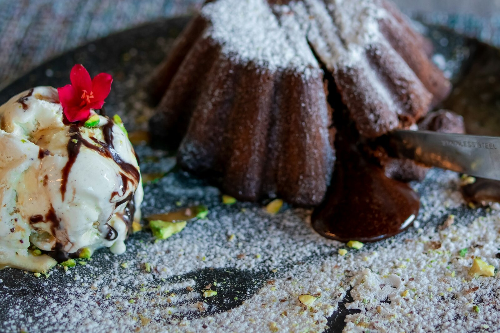 Molten dark chocolate cake with ice cream and powdered sugar