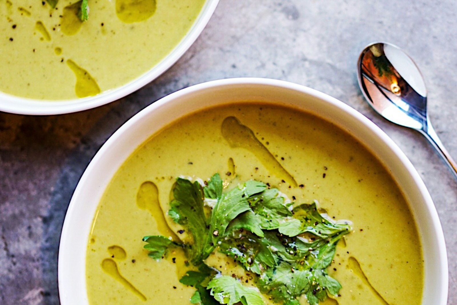 Bright green spring pea soup with mint and cream
