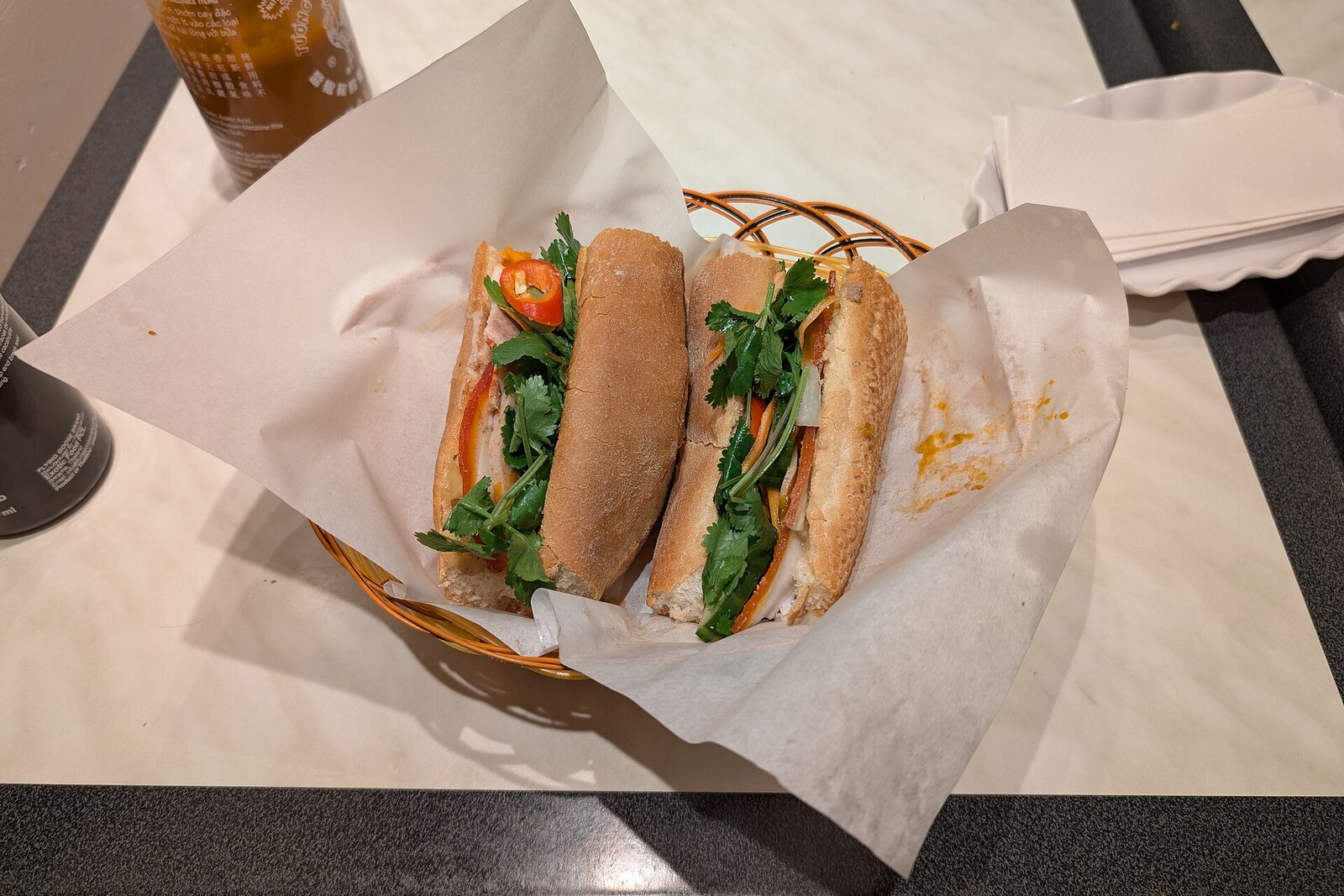 Vietnamese banh mi sandwich with pork, pickled vegetables, and cilantro