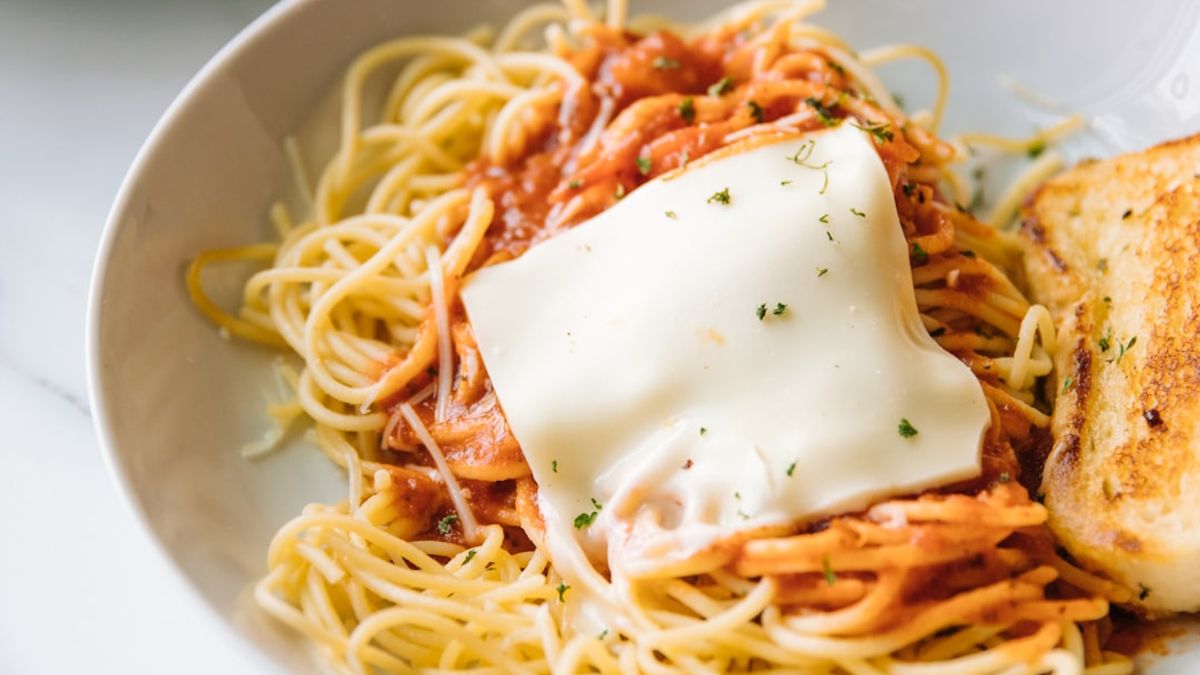 Valerie Bertinelli stirring tomato sauce for Italian-American family meal