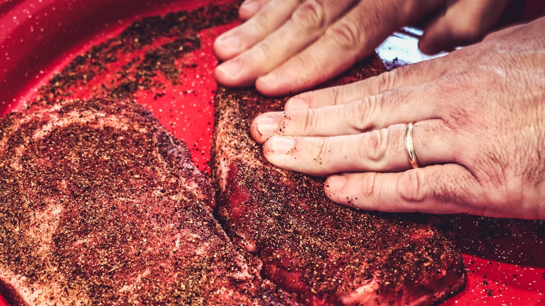 Seared cast iron ribeye steak with melting herb compound butter, rosemary, and thyme