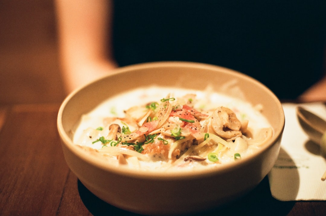 Creamy mushroom risotto in a wide bowl topped with shaved Parmesan and fresh thyme