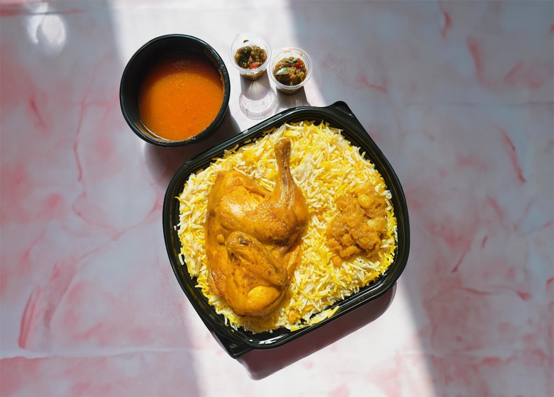 Crispy honey garlic chicken thighs with sticky glaze, sesame seeds, and green onions served over rice