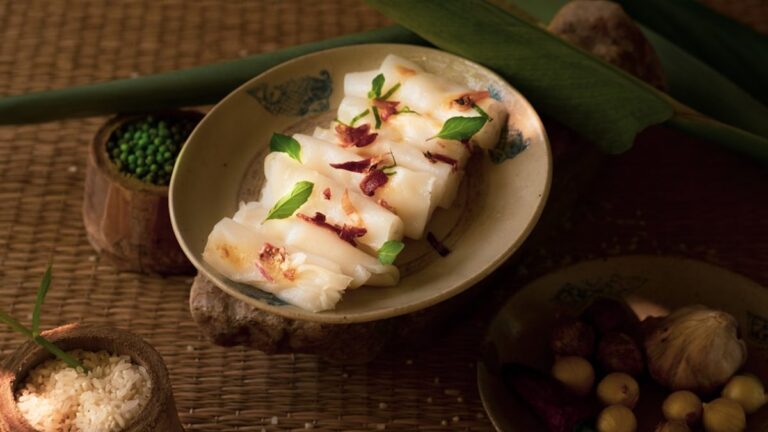Crispy sesame tofu cubes glazed with sweet chili sauce served with stir-fried vegetables