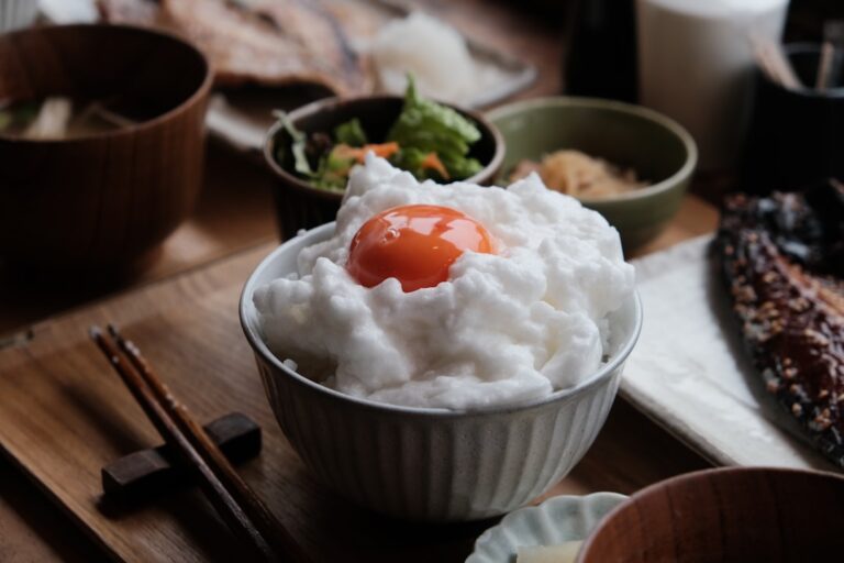Korean bibimbap rice bowl with colorful vegetable toppings, beef, and a fried egg