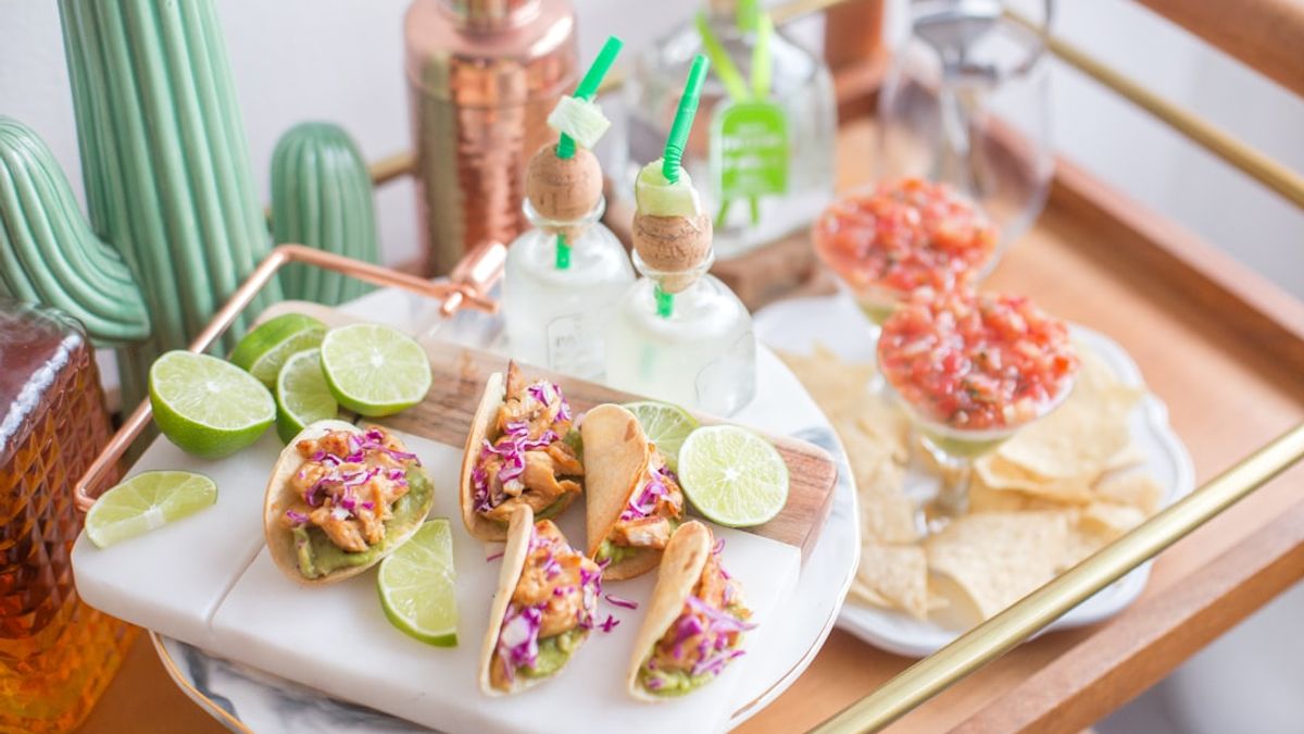 recipe booklet open showing tacos, grain bowls and colorful hot sauce bottles on a grocery shelf, illustrating swavory swangy food trends