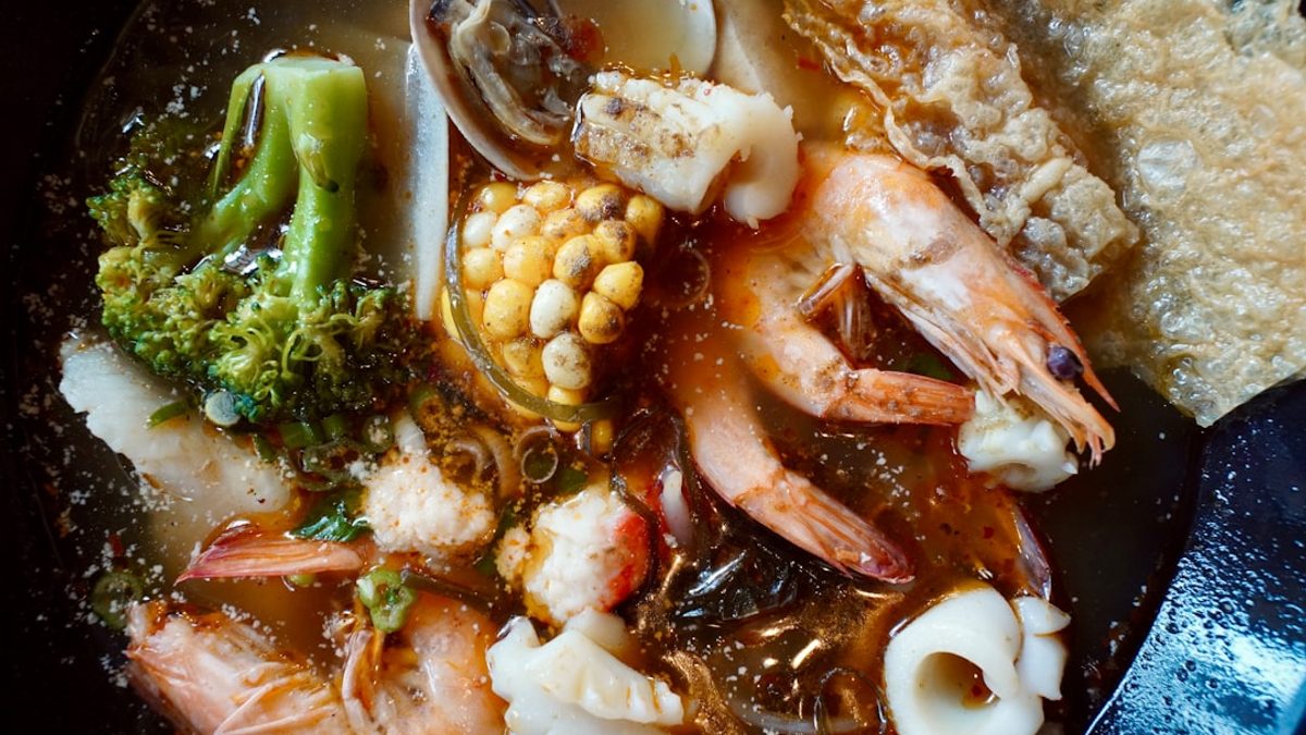 Seafood paella with saffron rice shrimp mussels and chorizo in a traditional pan