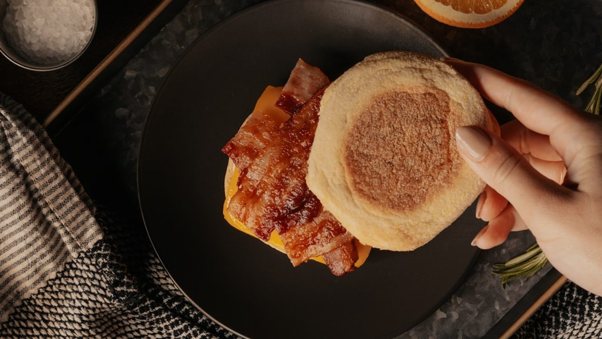 Stack of lemon ricotta pancakes topped with mixed berry compote and powdered sugar