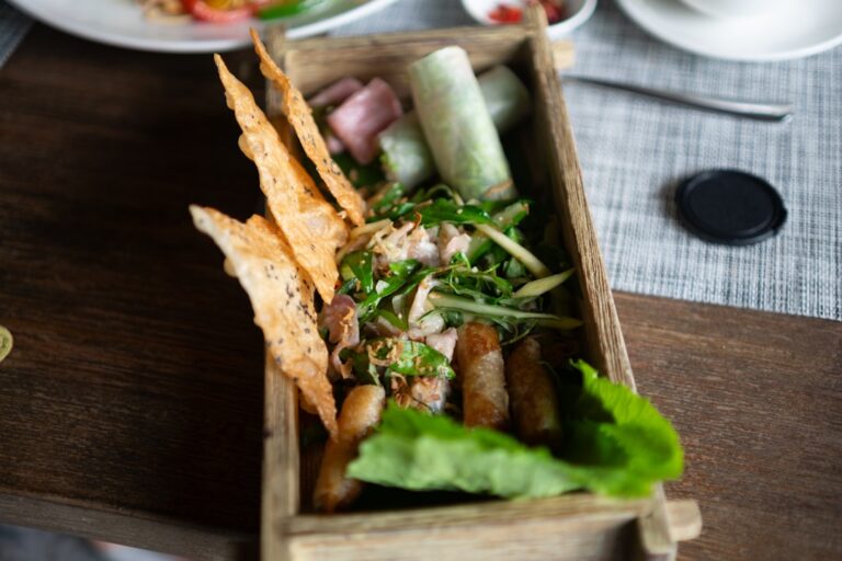 Fresh Vietnamese spring rolls with shrimp and vegetables alongside peanut dipping sauce