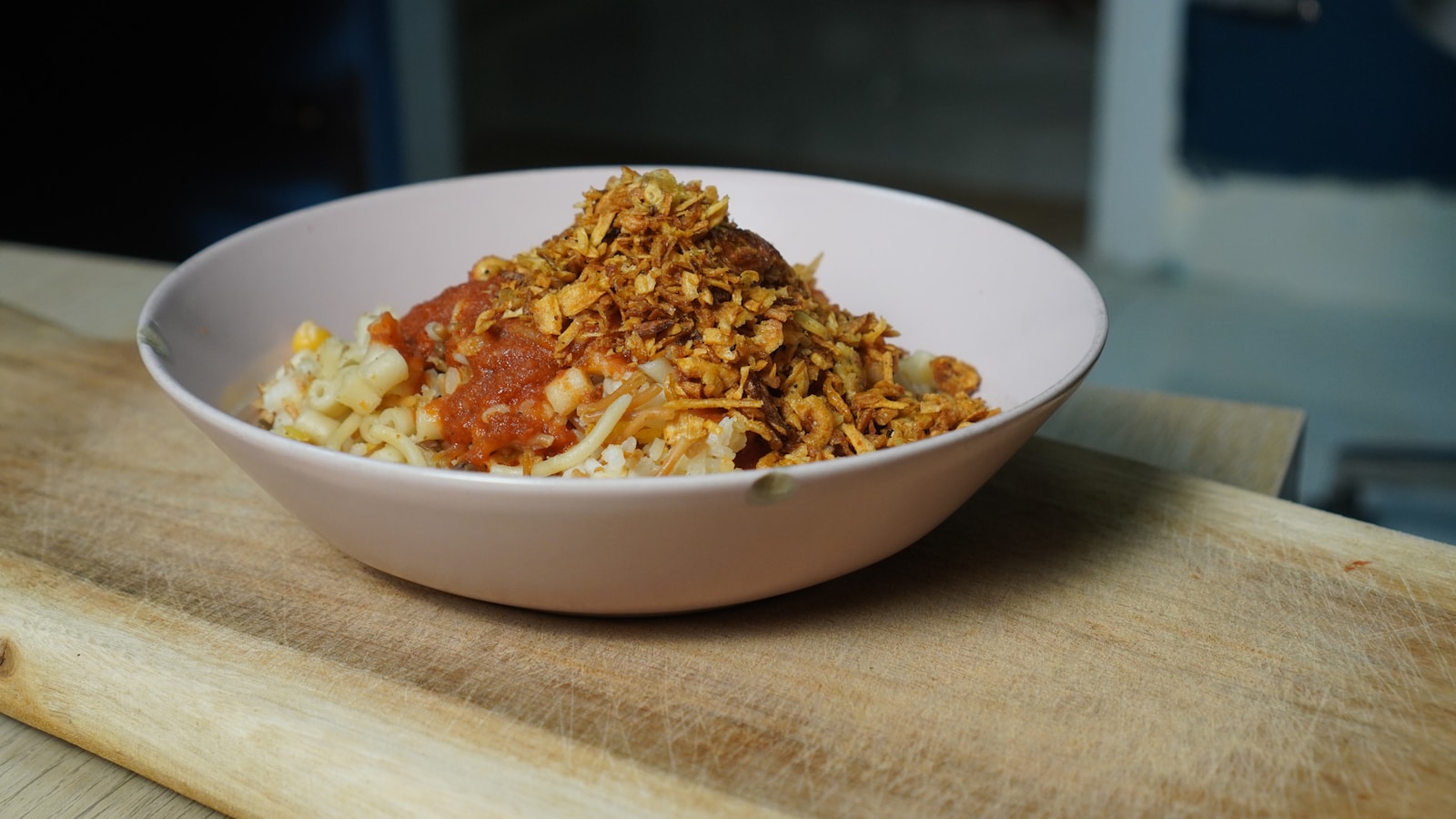 Flipped saffron rice cake on a serving platter, golden crust on top, scattered with barberries and pistachios