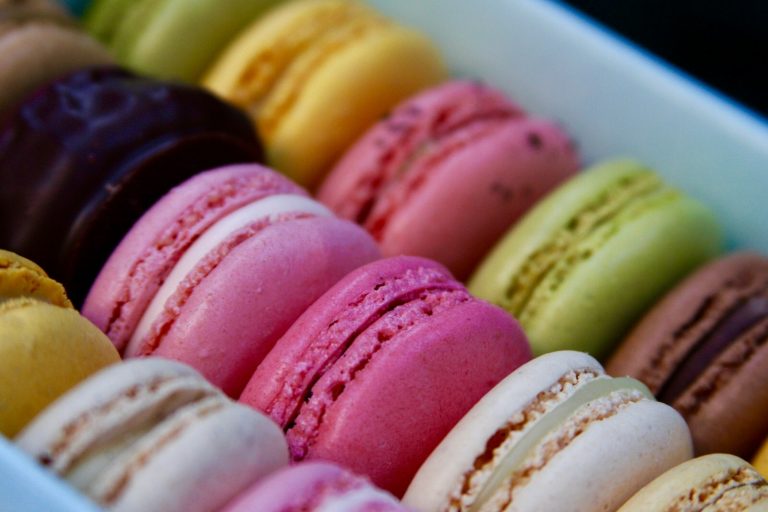 Colorful assortment of French macarons with smooth domes and ruffled feet