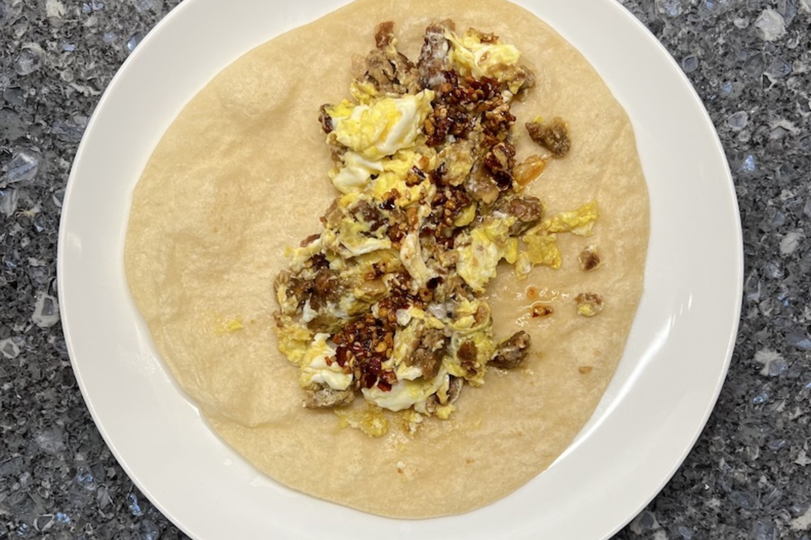 Tex-Mex breakfast tacos with scrambled eggs, bacon, cheese, and salsa