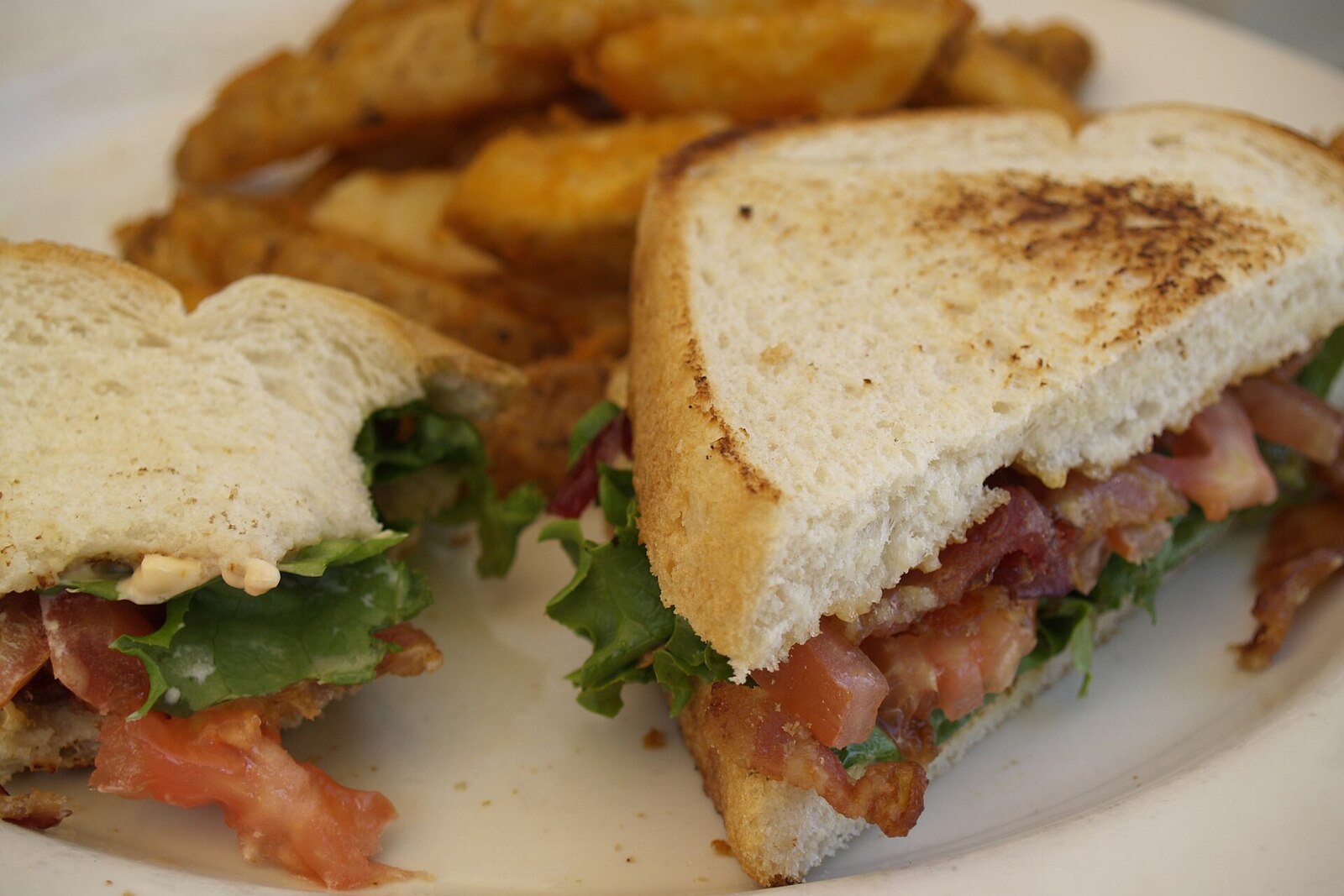 Classic American heirloom tomato sandwich on white bread with mayo