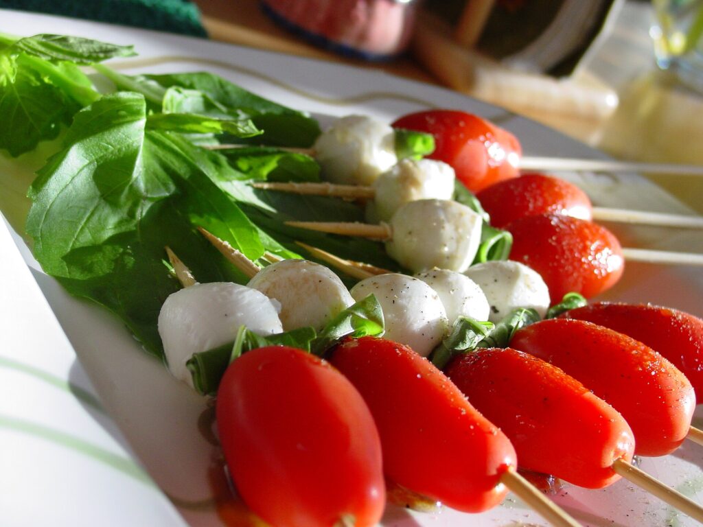 Small skewered appetizer bites arranged neatly on a rectangular serving tray