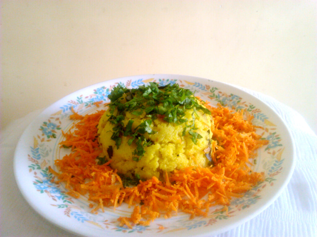 Coarsely chopped cabbage mixed with grated carrot and sliced onion in a wide bowl